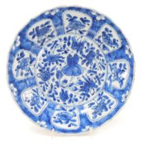 A Kangxi porcelain blue and white kraak plate, decorated with flowers, within a prunus blossom and c