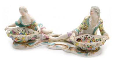 A pair of 19thC Meissen porcelain figural sweetmeat dishes, modelled as a reclining gallant and lady