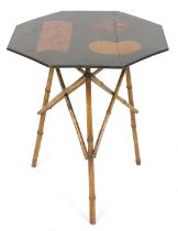 A late 19thC Japanese lacquer and bamboo occasional table, the octagonal top decorated with panels o
