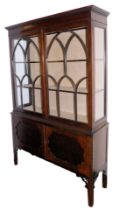 An Edwardian mahogany display cabinet, the dentil moulded pediment over a pair of astragal glazed do