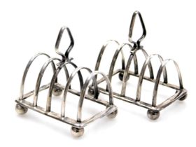 A pair of George V silver miniature four division toast racks, George Adie, Birmingham 1931, 1.36oz.