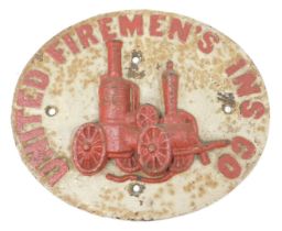 A cast iron oval property mark for United Fireman's Insurance Company, with raised fire engine decor