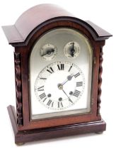 An Edwardian mahogany cased mantel clock, domed silvered dial, with chapter ring bearing Roman numer
