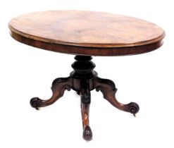 A Victorian walnut and inlaid tilt top breakfast table, the oval top raised on a carved turned colum