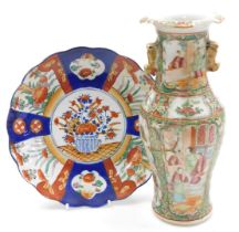 A Qing dynasty Cantonese famille rose porcelain vase, of twin handled, baluster form, decorated with