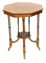 A Victorian mahogany window table, the octagonal top raised on four triple column supports, united b