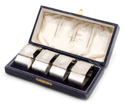 A set of four George V Art Deco silver napkin rings, with engine turned and geometric decoration, ca