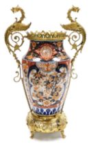 A Meiji period Imari porcelain and ormolu mounted vase, the coronet topped vase, with griffin handle