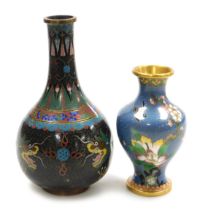 A Chinese black ground cloisonne vase, of bottle form, decorated with Imperial dragons chasing a fla
