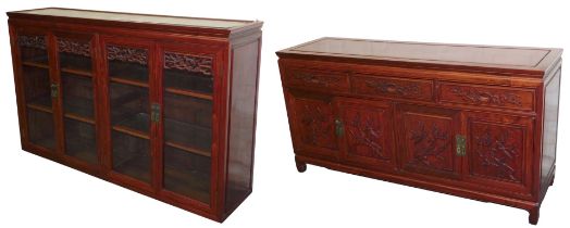 A Chinese hardwood sideboard, with three frieze drawers, carved with prunus blossom above two pairs