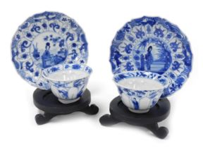 A pair of Kangxi porcelain blue and white tea bowls and saucers, of moulded floral form, decorated w