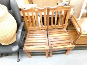 Two wooden chairs, with slatted bases and turned legs.