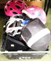 Various cycle helmets and a fencing helmet.