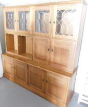 A oak display cabinet, with gallery back, leaded windows, two doors over a base unit of four doors,