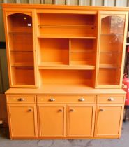 An orange painted dresser, with two glazed doors flanking shelving unit above single long drawer fla