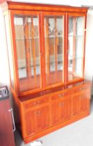 A display cabinet, with three glazed doors to the top, above three drawers and three cupboard doors,