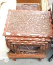 Anglo-Asian carved nest of four tables, and a coffee table with glass top and carving below.