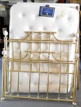 A double bed, with two divan bases and a pocket sprung mattress with a brass head and tail board. Th