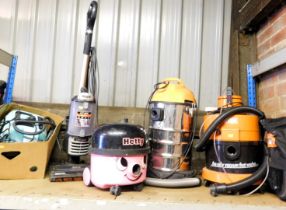 Vacuum cleaners, including a Henry, two Vax upright, Shark, and various tools. (1 shelf)