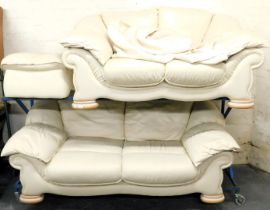 A two piece leather suite, upholstered in cream, one two seater and one three seater.