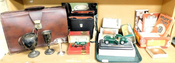 Trophies, briefcase, pair of binoculars, toy cars and games, etc. (1 shelf)