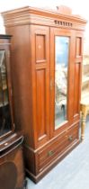 A Victorian double wardrobe, with single bevelled mirrored door, over single drawer, raised on plint