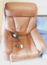 A tan leather electric reclining armchair. This lot is located at our additional premises SALEROOM S