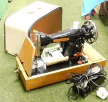 A cased electric sewing machine.