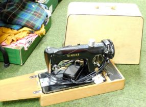 A cased Singer electric sewing machine. Buyer Note: WARNING! This lot contains untested or unsafe el