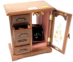 A jewellery box containing various necklaces, brooches, etc.