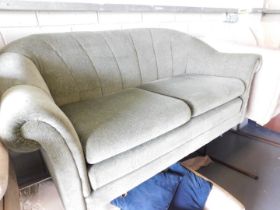 A two seater green upholstered sofa. This lot is located at our additional premises SALEROOM SIX, Un