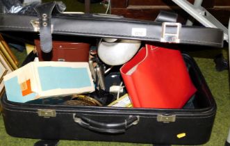 A suitcase containing an angle poise lamp, binoculars etc. Buyer Note: WARNING! This lot contains