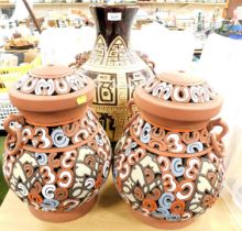 A large geometric style brown glazed vase, and two multicoloured lamp bases.