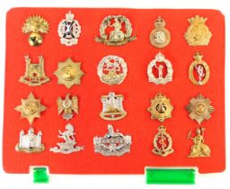 A group of military cap badges, to include Royal Army Medical Corps, 7th Dragoon Guards, Royal Corps
