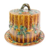 A majolica cheese dish and cover, of barrel form, moulded with flowers and leaves, number 1689, 30cm