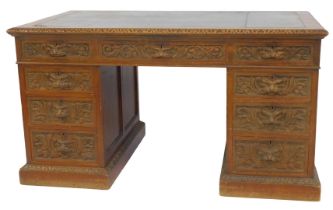 A Victorian carved oak twin pedestal desk, with leather top and carved mask head handles, 180cm x 82