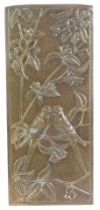 A Mid Century brass picture, embossed with a pair of budgerigars in a tree with blossom, 35.5cm x 15