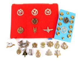 A group of military cap badges, buttons, etc., to include East Surrey Regiment, Cambridgeshire Regim