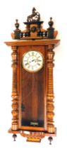 A 19thC mahogany Gustav Becker Vienna wall clock, with an arched pediment top, set with horse and li