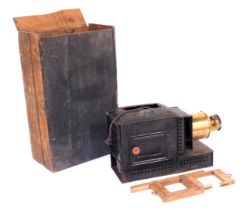 A Victorian brass and tin magic lantern, boxed.