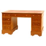 An early 20thC oak kneehole desk, with inset red leather top and fitted with a three drawers to the