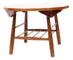 An Arts and Crafts influenced copper topped coffee table, the circular top above Ercol base, with un