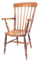 A late 19thC elm and beech stick back arm chair, with an arched rail and turned legs, 99cm high, 56c