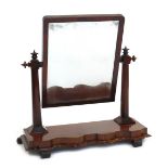 A Victorian mahogany toilet mirror, the rectangular mirror supported by octagonal columns with turne