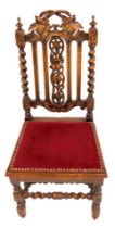 A late Victorian carved oak Carolean style chair, with fruiting vine cresting rail and splat, spiral