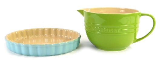 Two items of Le Creuset, comprising a green Le Creuset measuring cup, 12-02, 12cm high, and a turquo