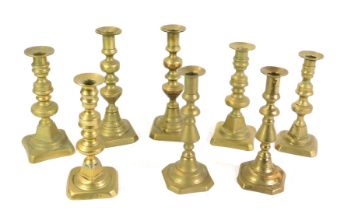 Four pairs of 19thC brass candlesticks, 20cm-23cm high.