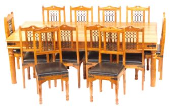 An Indonesian hardwood rectangular dining table, with plain plank top and frieze, on plain cylindric