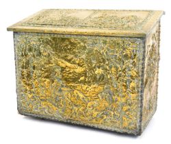 An embossed brass box, the hinged lid with panels of religious figures in woodland, with a two secti