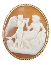 A 19thC shell cameo brooch/pendant, with raised relief figure reclined on sofa and winged figure dri